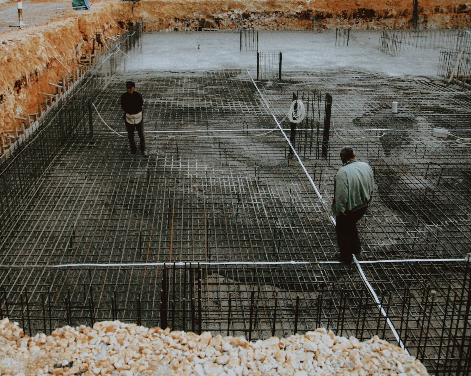 Steel reinforcement set across a concrete foundation