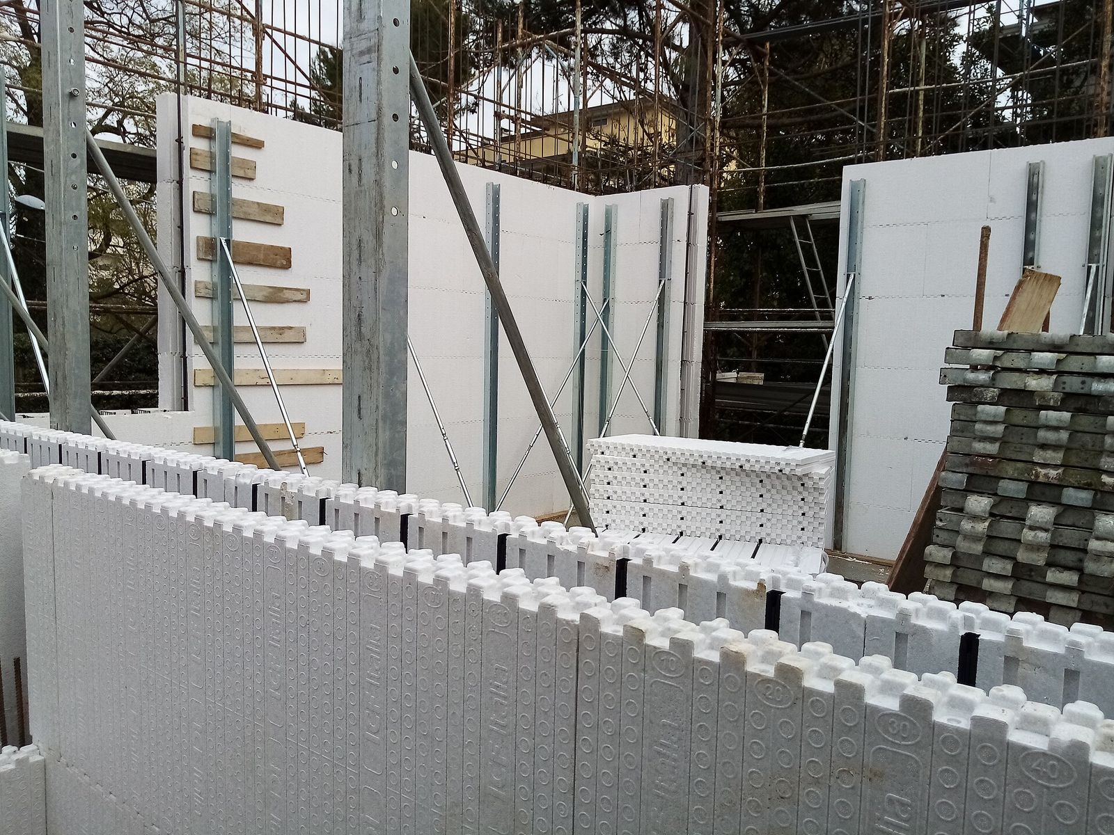 Interlocking foam ICF blocks stacked into a foundation wall, showing the grid of the forms
